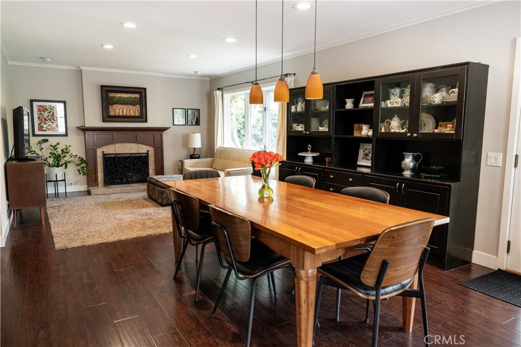 26251 Brookhollow Lake Forest, CA 92630 - Photo 9 of 27 a dining room with furniture a fireplace and wooden floor
