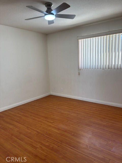 1901 Scott Road Burbank, CA 91504 - Photo 7 of 14 an empty room with wooden floor fan and windows