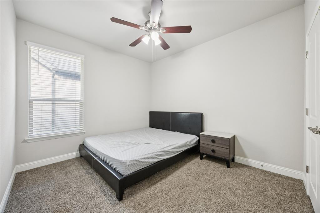 11520 Lavonia Road Fort Worth, TX 76244 - Photo 20 of 32 a bedroom with a bed and a window