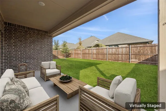 a view of a patio with couches chairs and a yard