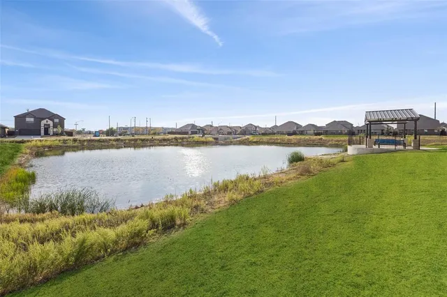 a view of a lake with houses in the back