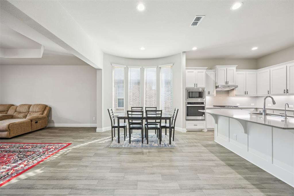 11520 Lavonia Road Fort Worth, TX 76244 - Photo 10 of 32 a dining room with furniture and wooden floor