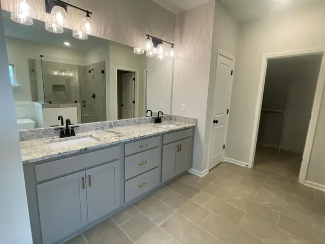 a bathroom with a granite countertop sink a toilet and a tub