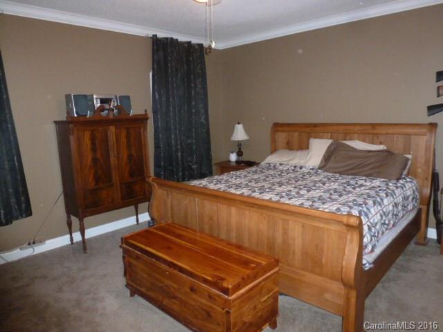4375 Camp Creek Road Lancaster, SC 29720 - Photo 14 of 24 a bedroom with a bed and wooden floor