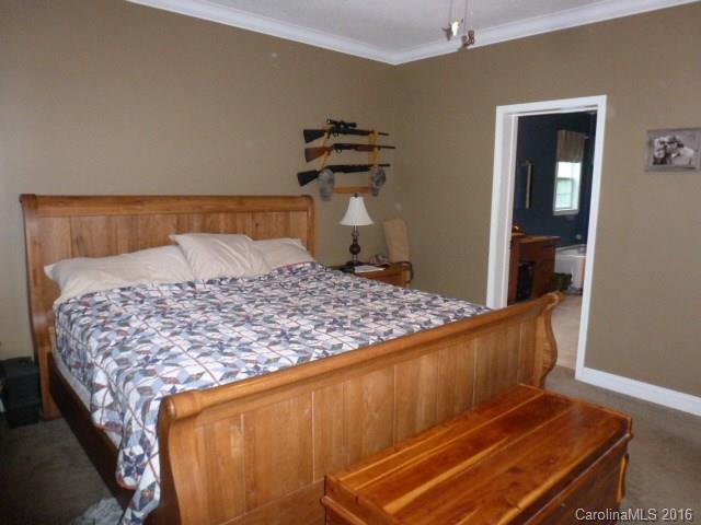 4375 Camp Creek Road Lancaster, SC 29720 - Photo 15 of 24 a bed sitting in a bedroom next to a window