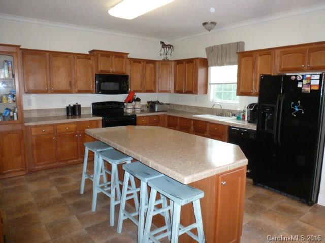 4375 Camp Creek Road Lancaster, SC 29720 - Photo 9 of 24 a kitchen with granite countertop a sink stove and refrigerator