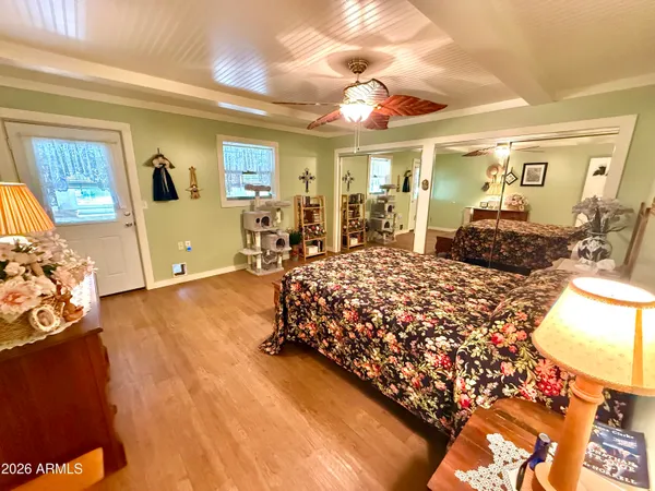 a bedroom with a large bed and a chandelier