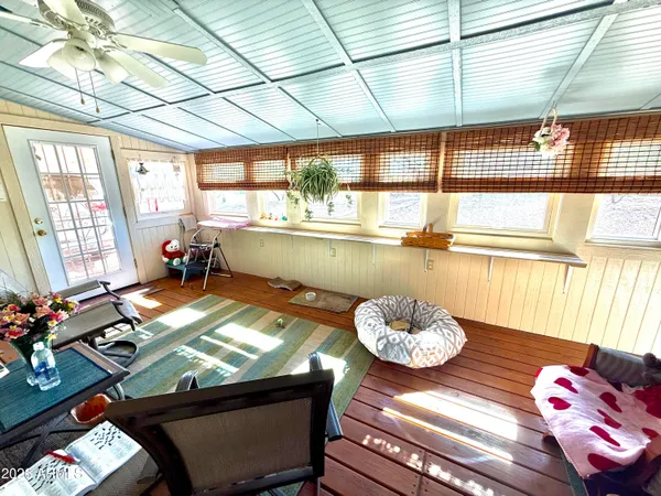 a living room with furniture and a floor to ceiling window