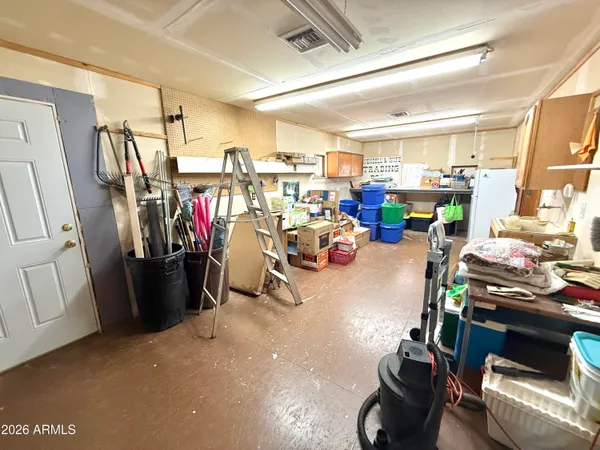 a view of a storage room with furniture fridge and stairs