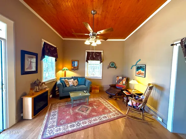 a living room with furniture a rug and a chandelier