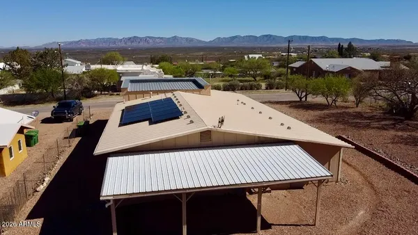 an aerial view of a house with a yard and parking space