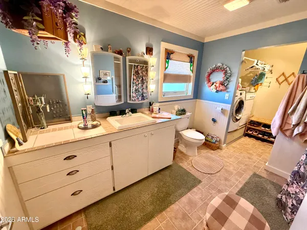 a bathroom with a double vanity sink mirror and bathtub