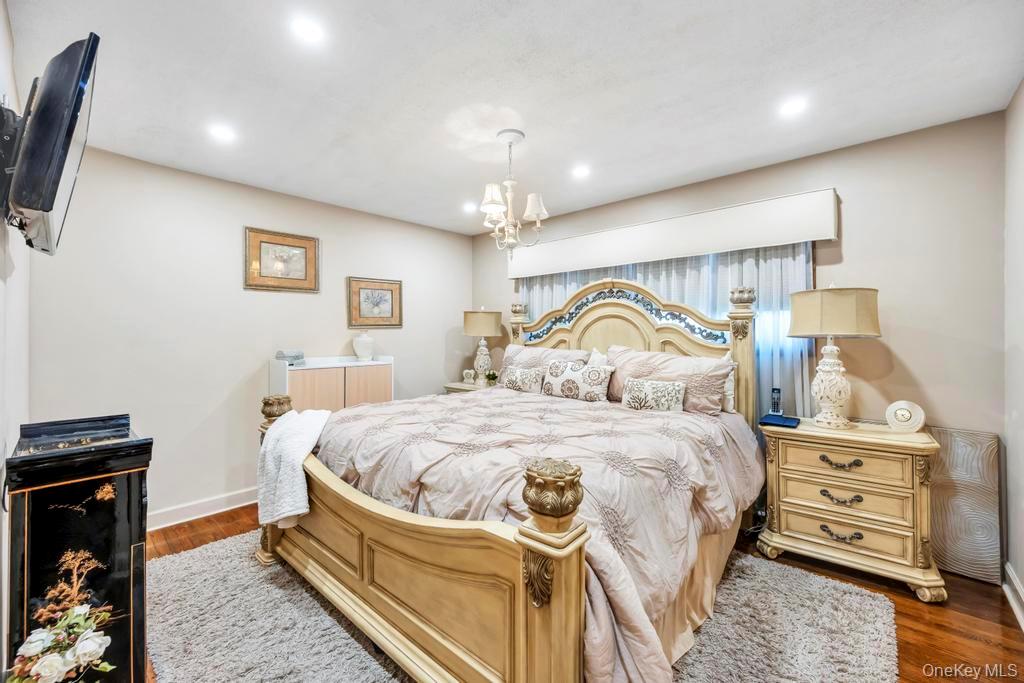 60 Essex Road Bethpage, NY 11714 - Photo 13 of 21 Bedroom featuring recessed lighting and dark wood-style flooring
