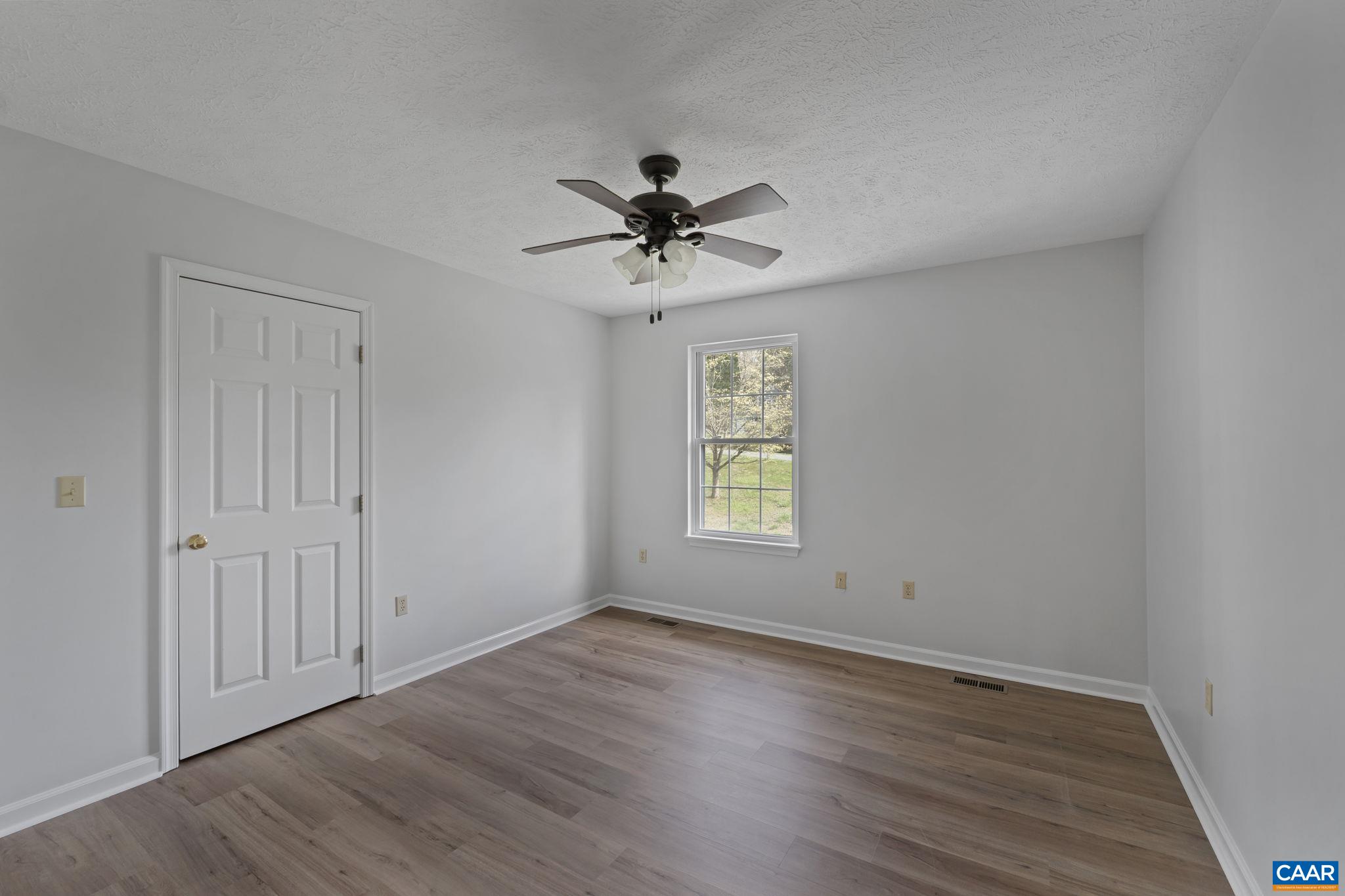 255 Rustling Oaks Way Ruckersville, VA 22968 - Photo 13 of 18 wooden floor in an empty room with a window
