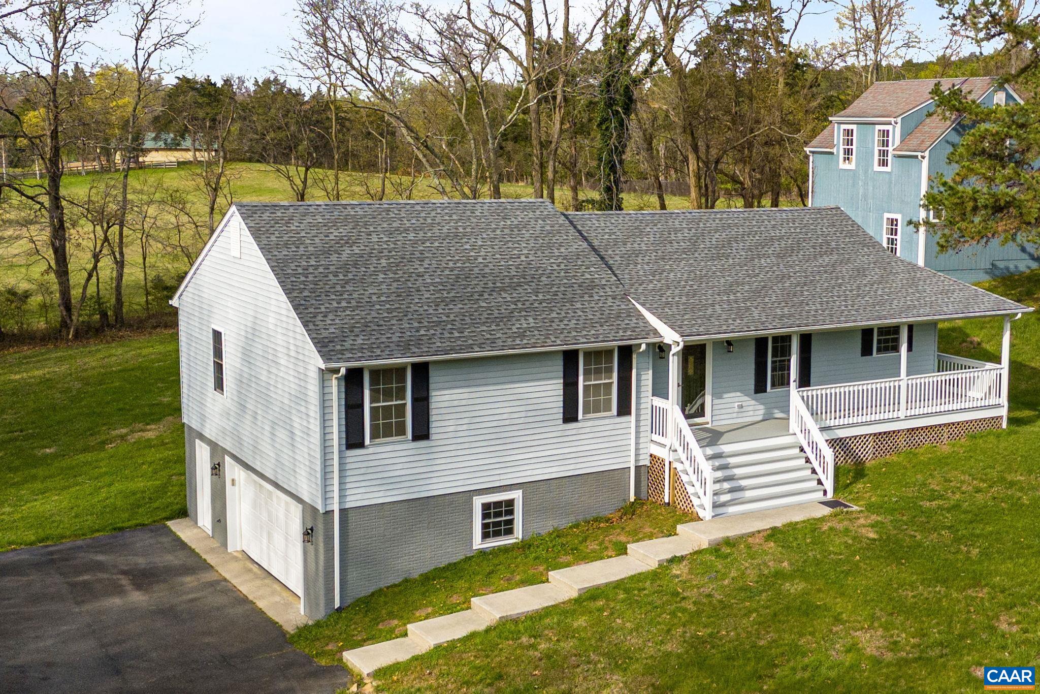 255 Rustling Oaks Way Ruckersville, VA 22968 - Photo 3 of 18 a view of house with backyard and trees