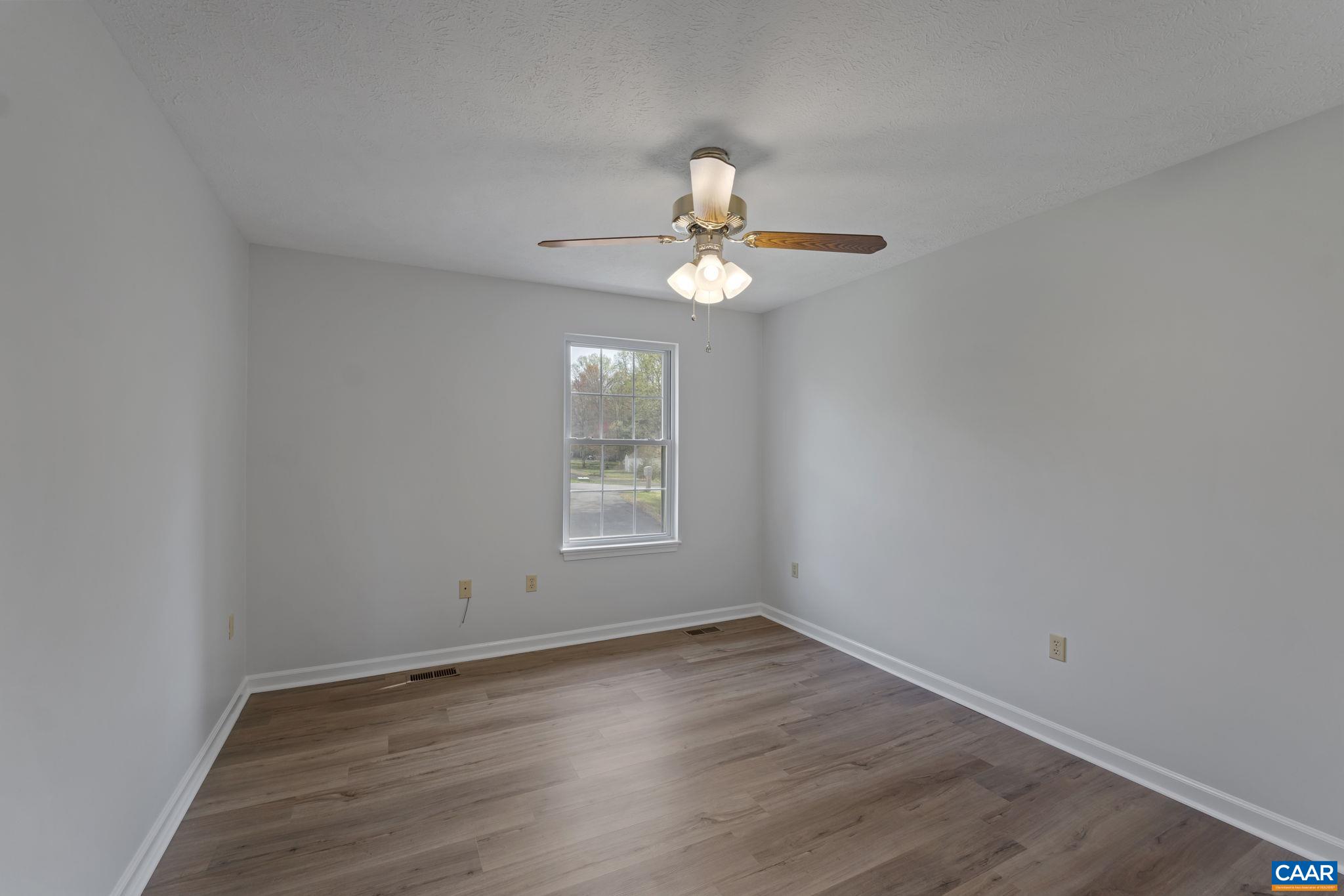 255 Rustling Oaks Way Ruckersville, VA 22968 - Photo 10 of 18 wooden floor in an empty room with a window