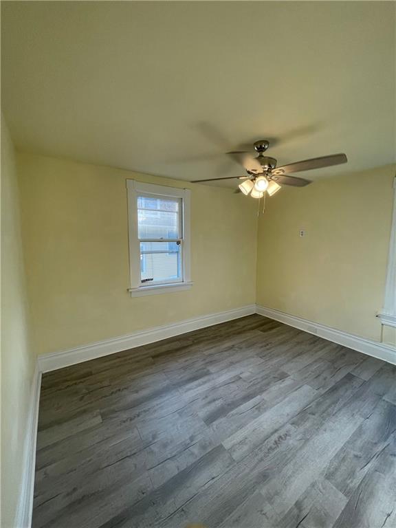 416 Sumner Avenue New Castle, PA 16105 - Photo 12 of 18 a view of an empty room with wooden floor and a window