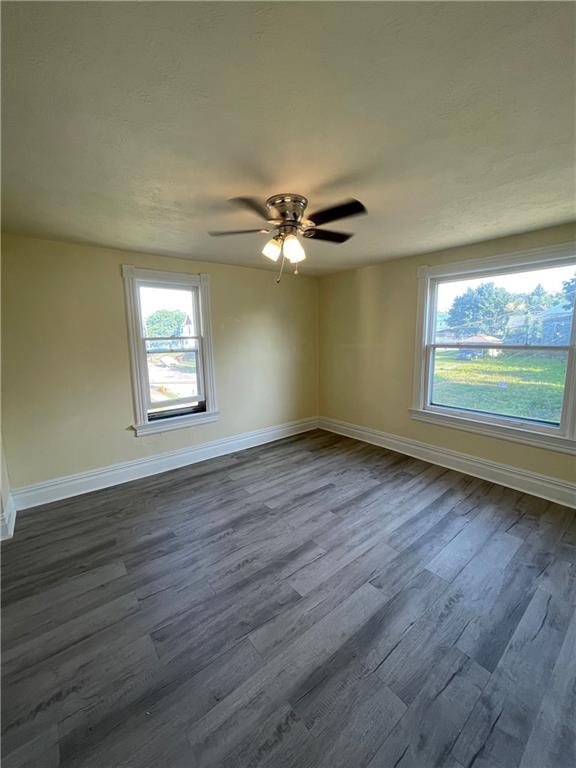 416 Sumner Avenue New Castle, PA 16105 - Photo 13 of 18 a view of an empty room with wooden floor and a window