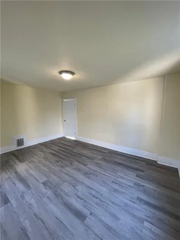 an empty room with wooden floor