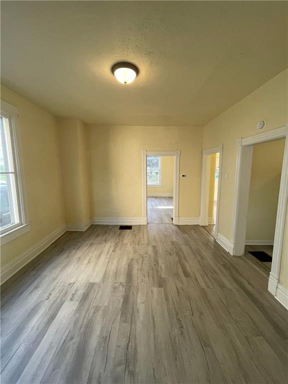 416 Sumner Avenue New Castle, PA 16105 - Photo 5 of 18 an empty room with wooden floor and windows