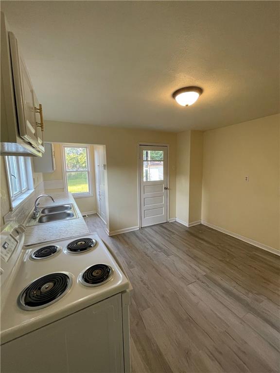 416 Sumner Avenue New Castle, PA 16105 - Photo 7 of 18 a kitchen that has a stove and a wooden floor