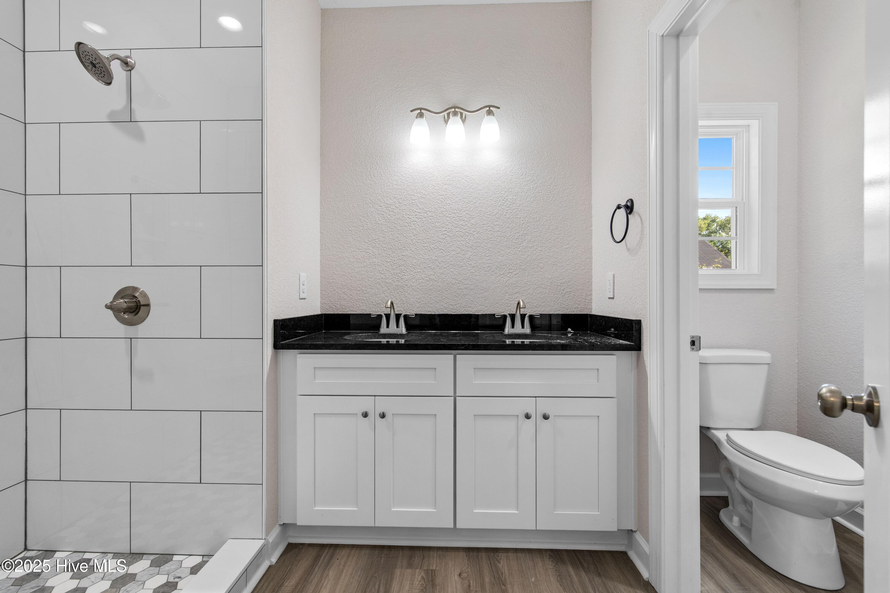 158 Texas Road Shiloh, NC 27974 - Photo 20 of 43 Primary Bathroom with double basin vanity and separate toilet room.