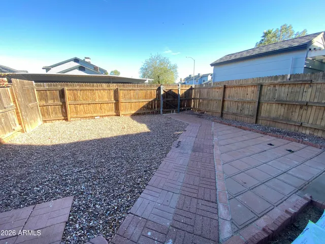 a view of a backyard with table and chairs