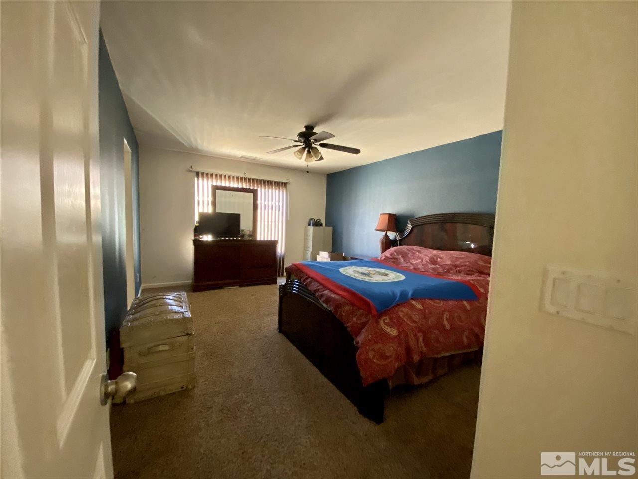 1935 Bears Ranch Drive Reno, NV 89521 - Photo 12 of 16 a bedroom with a bed and a chandelier