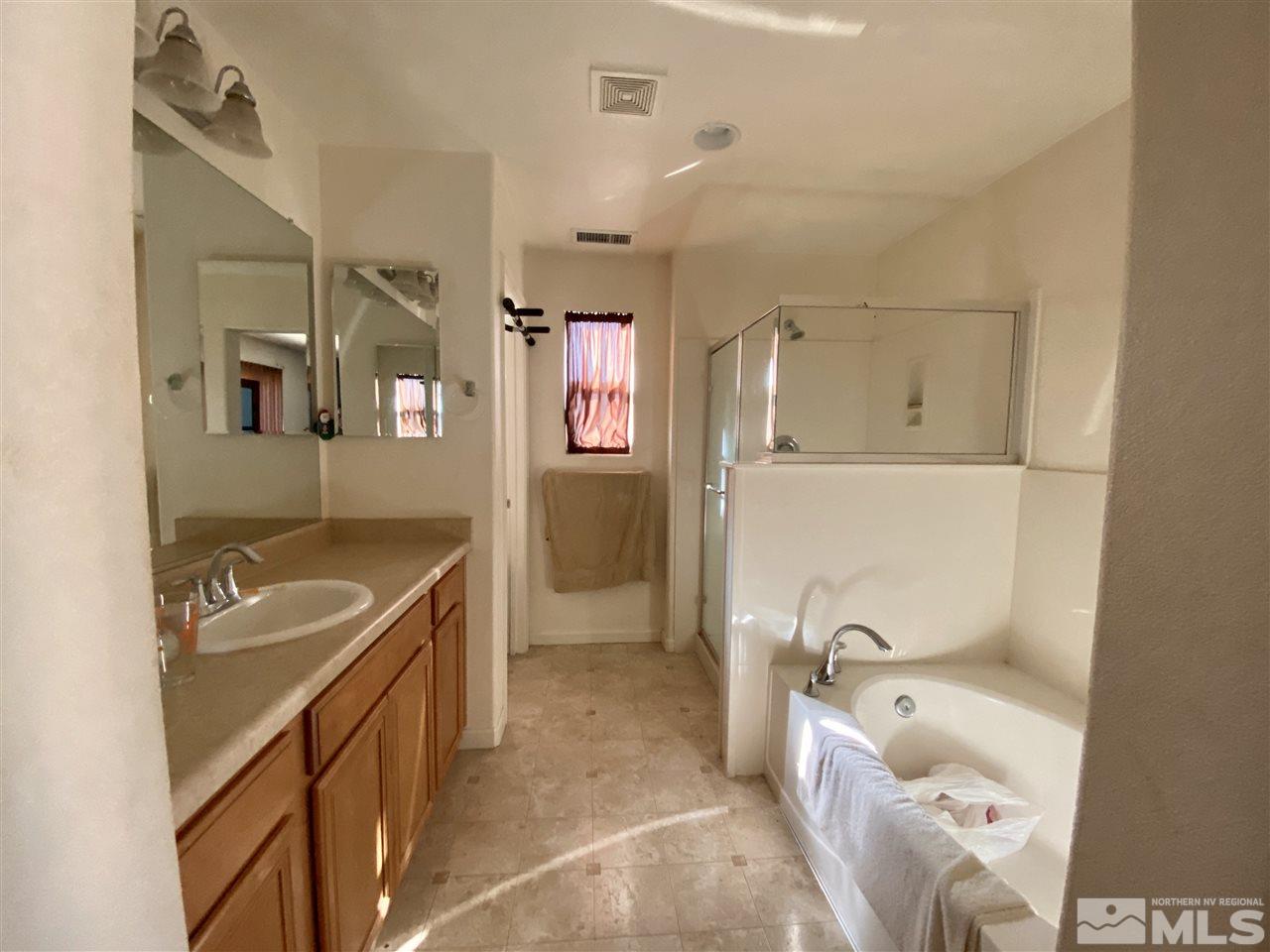 1935 Bears Ranch Drive Reno, NV 89521 - Photo 13 of 16 a bathroom with a tub sink and mirror