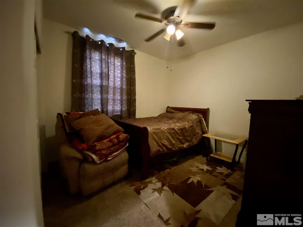 1935 Bears Ranch Drive Reno, NV 89521 - Photo 5 of 16 a bedroom with furniture and a chandelier