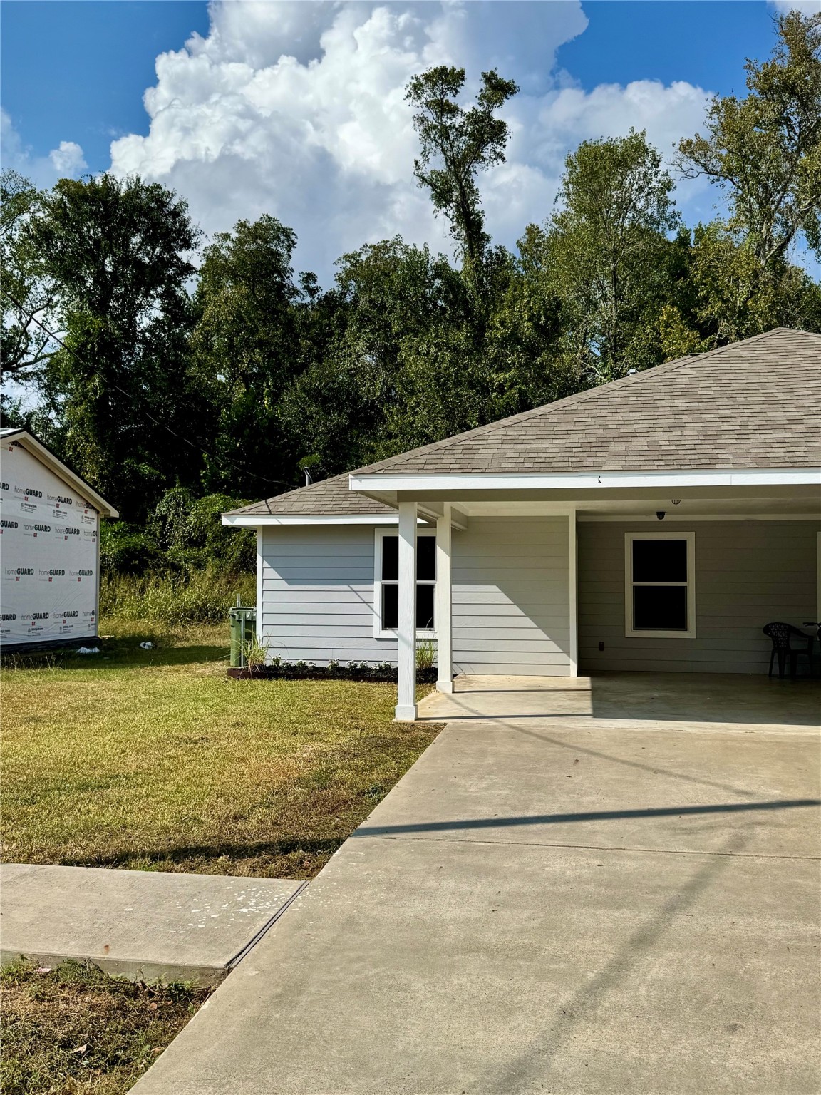 a view of a house with a yard and garage
