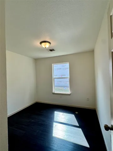 an empty room with wooden floor