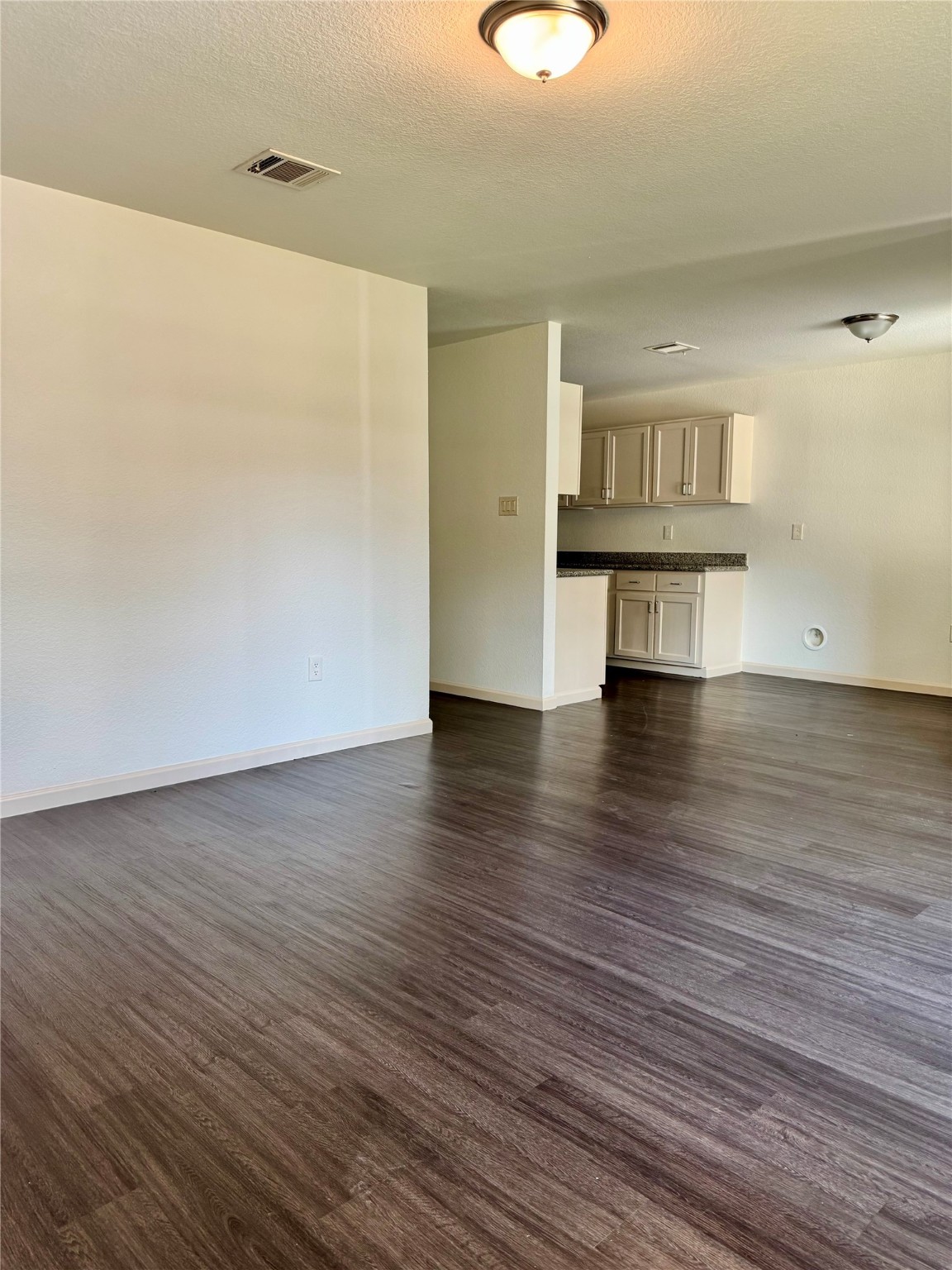624 Luke Street, Unit A Dayton, TX 77535 - Photo 4 of 20 a view of empty room with wooden floor