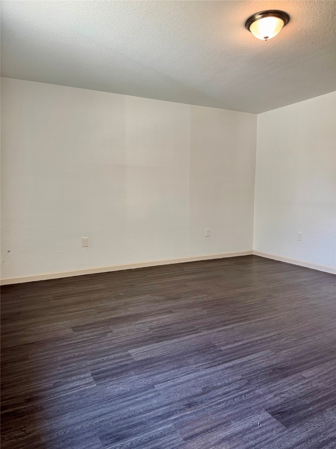 624 Luke Street, Unit A Dayton, TX 77535 - Photo 5 of 20 a view of an empty room with wooden floor