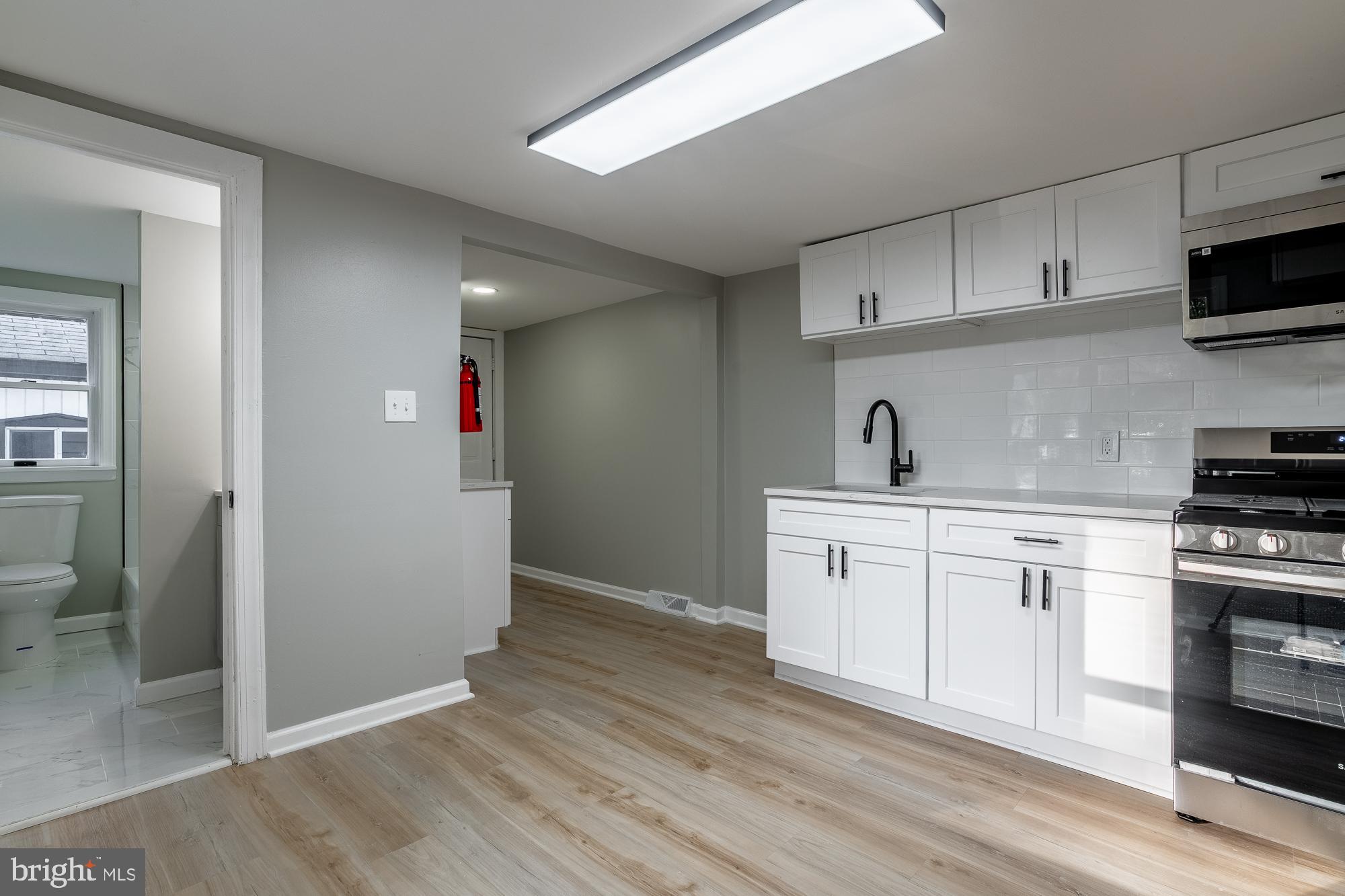127 West Holly Avenue Pitman, NJ 08071 - Photo 13 of 23 a kitchen with cabinets stainless steel appliances and sink
