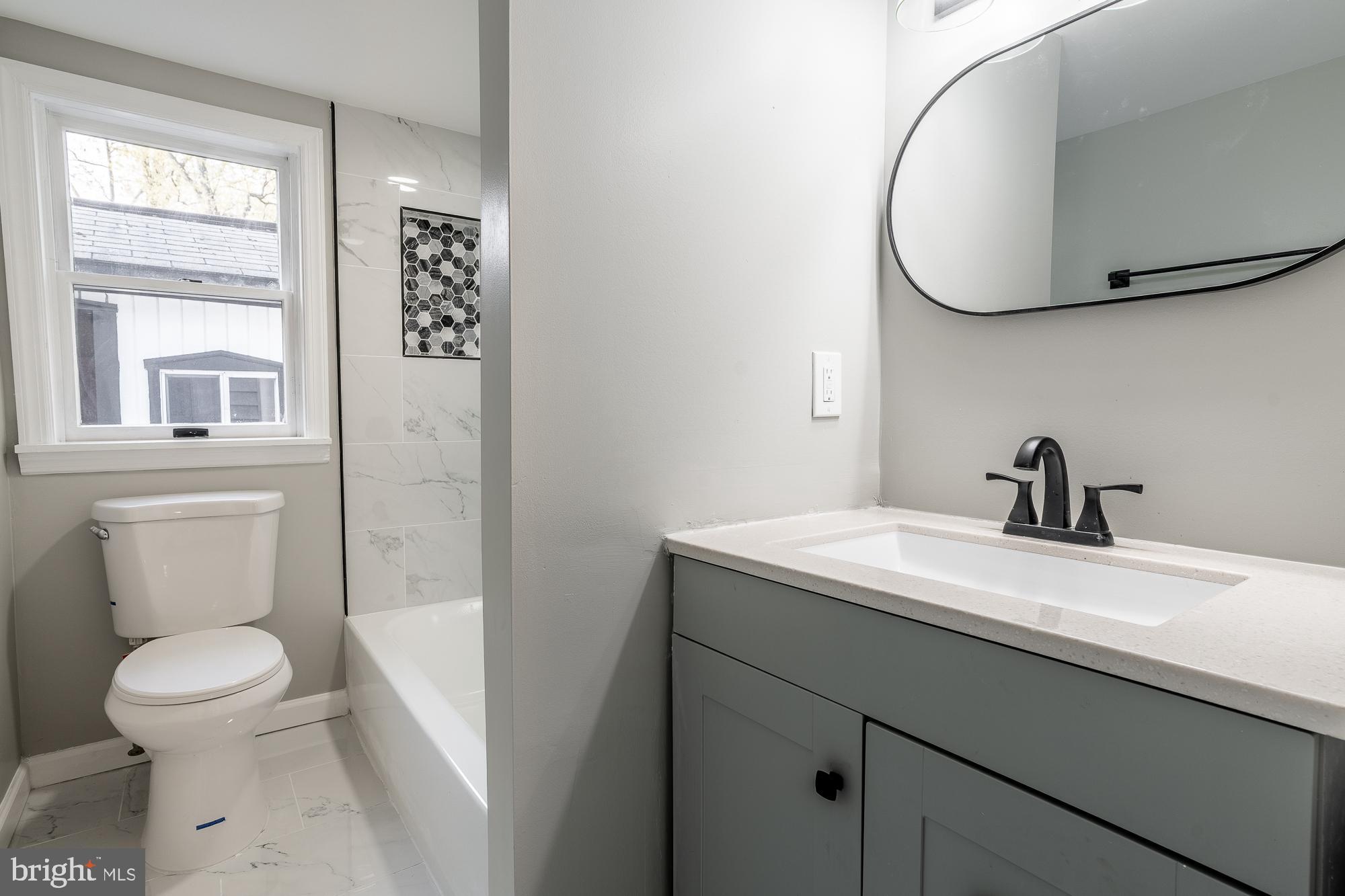127 West Holly Avenue Pitman, NJ 08071 - Photo 17 of 23 a bathroom with a toilet sink vanity and mirror