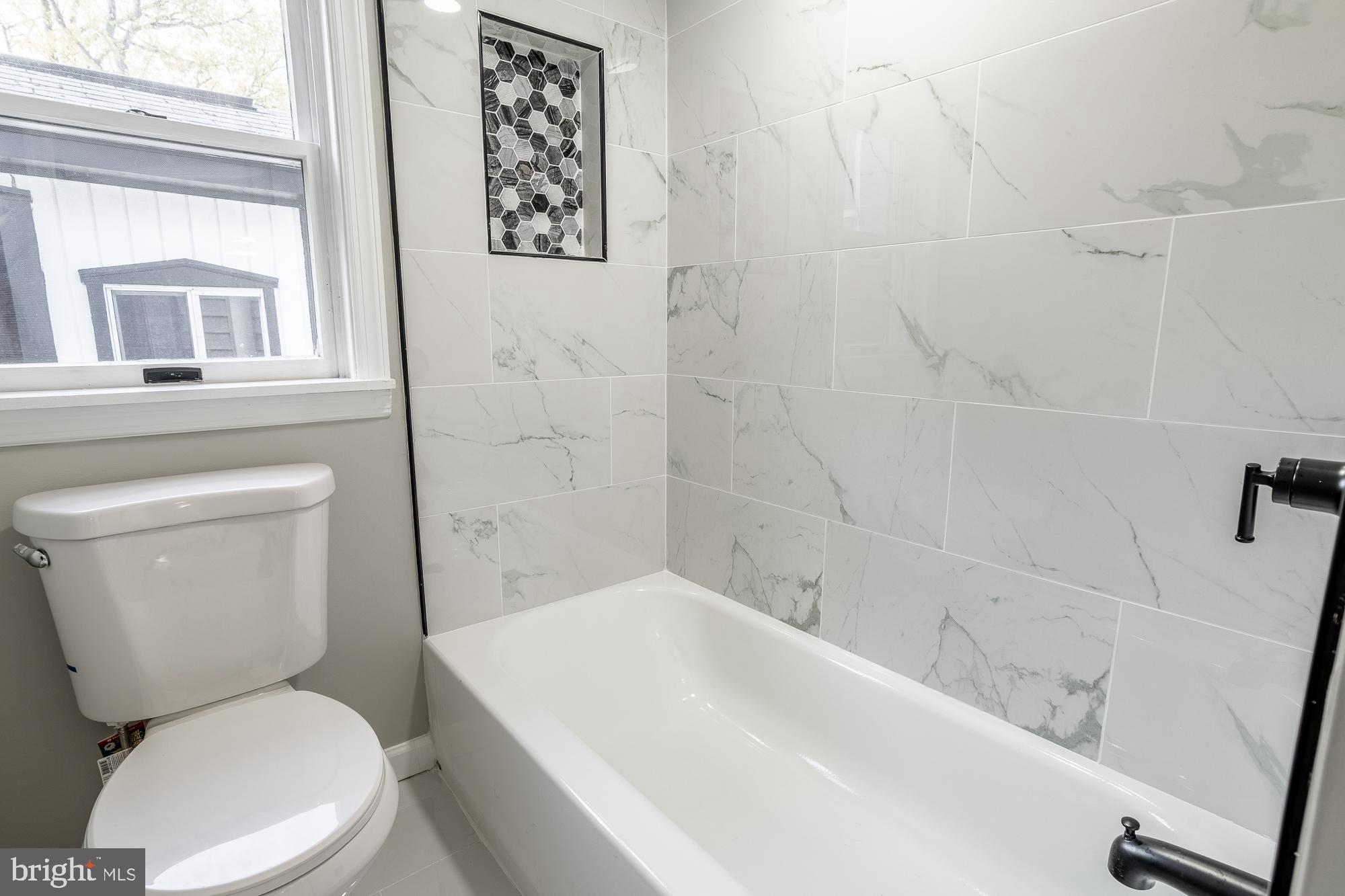 127 West Holly Avenue Pitman, NJ 08071 - Photo 18 of 23 a white toilet sitting next to a bath tub