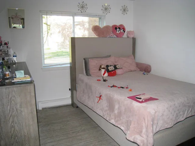 a bedroom with a bed and window