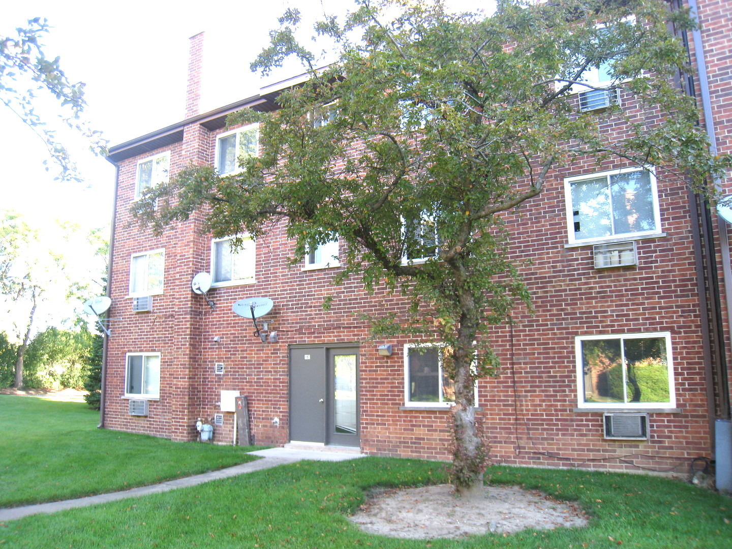 187 Pickwick Drive, Unit 1A Schaumburg, IL 60193 - Photo 14 of 17 a front view of a house with garden