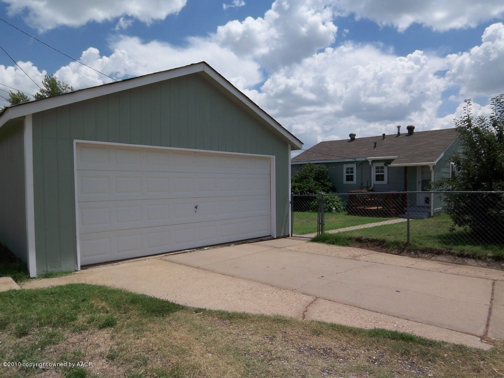 1614 Southwest 48th Avenue Amarillo, TX 79110 - Photo 12 of 13 a backyard of a house with garage