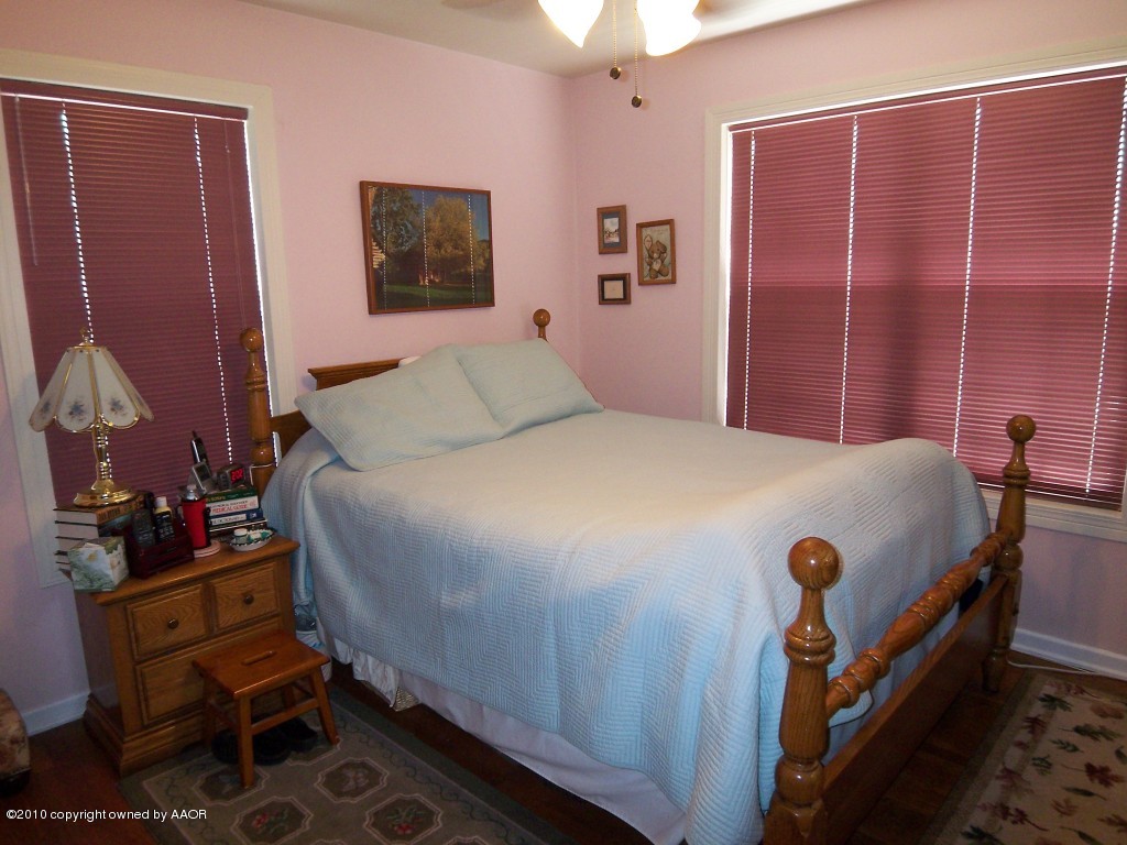 1614 Southwest 48th Avenue Amarillo, TX 79110 - Photo 3 of 13 a bedroom with a bed and wooden floor