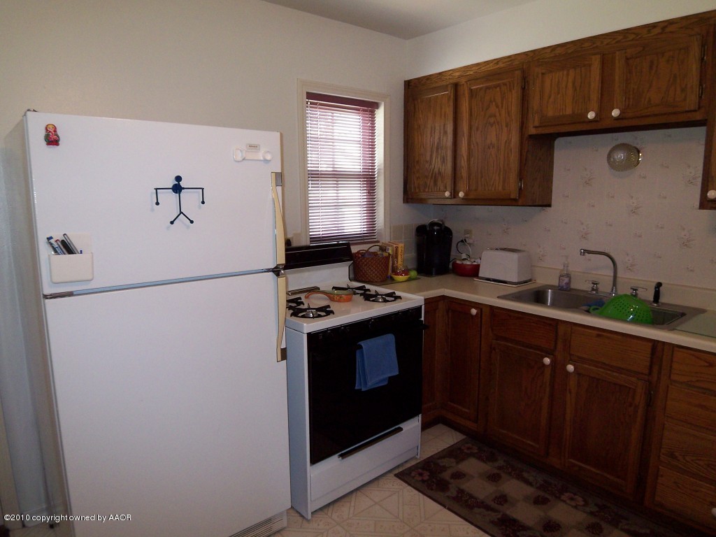 1614 Southwest 48th Avenue Amarillo, TX 79110 - Photo 6 of 13 a kitchen with stainless steel appliances granite countertop a refrigerator a sink and a stove