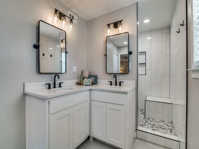 a bedroom with two beds and a chandelier