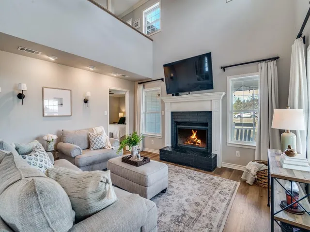 a kitchen with stainless steel appliances kitchen island granite countertop a stove a sink and white cabinets