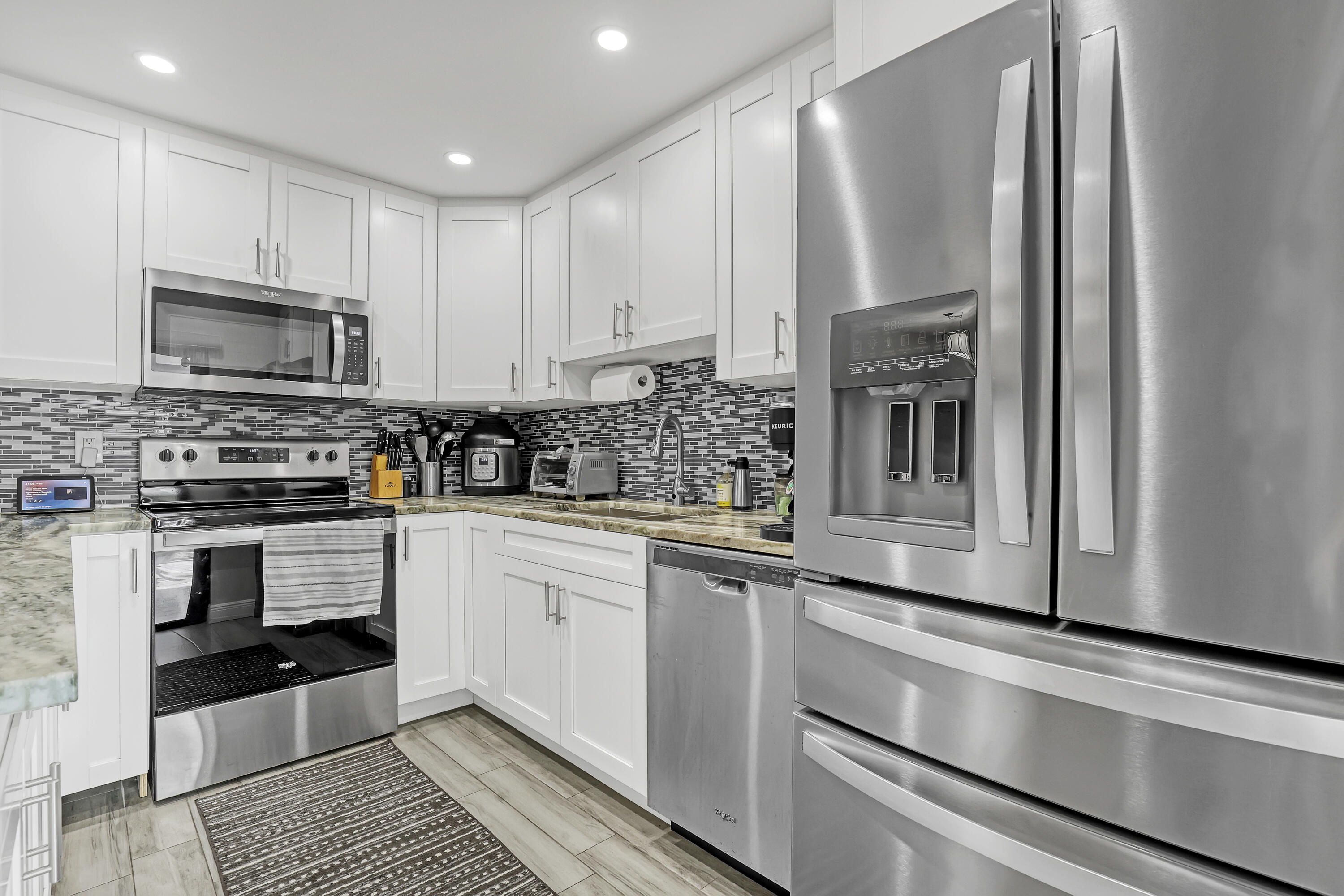 923 Springdale Circle Palm Springs, FL 33461 - Photo 14 of 26 a kitchen with stainless steel appliances granite countertop a stove a sink and a microwave