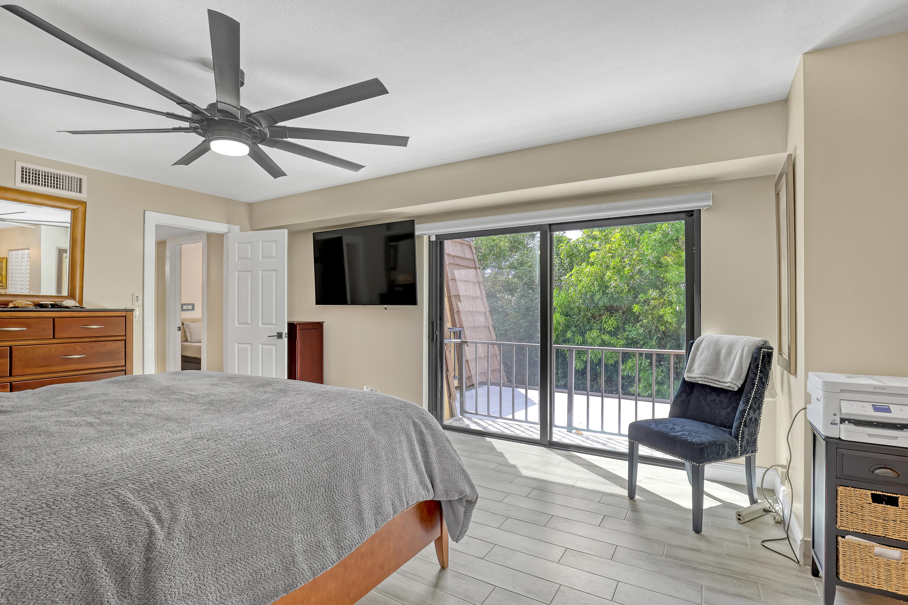 923 Springdale Circle Palm Springs, FL 33461 - Photo 17 of 26 a bed room with a bed and a chair