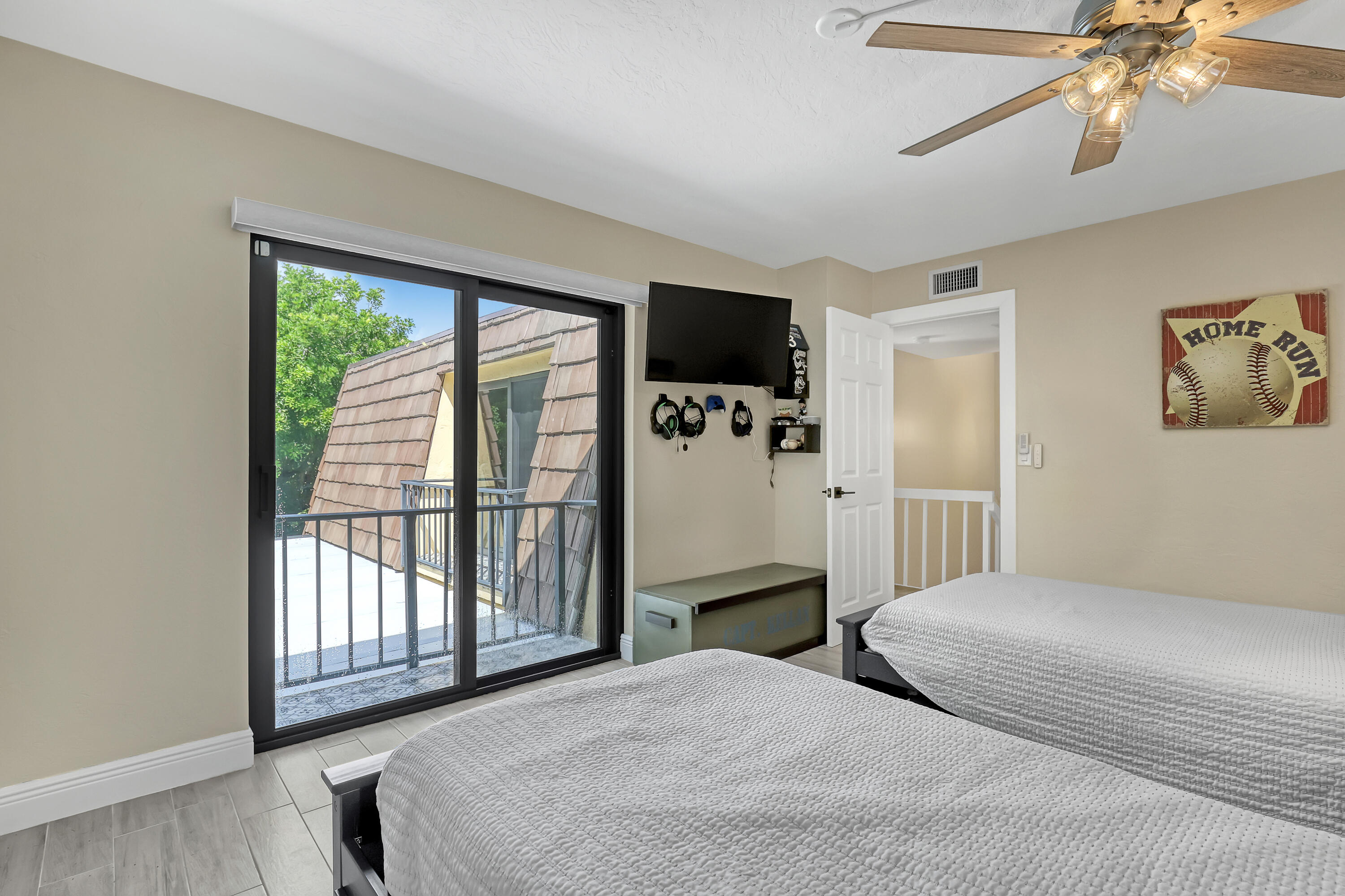 923 Springdale Circle Palm Springs, FL 33461 - Photo 23 of 26 a bedroom with a balcony a bed and a flat screen tv