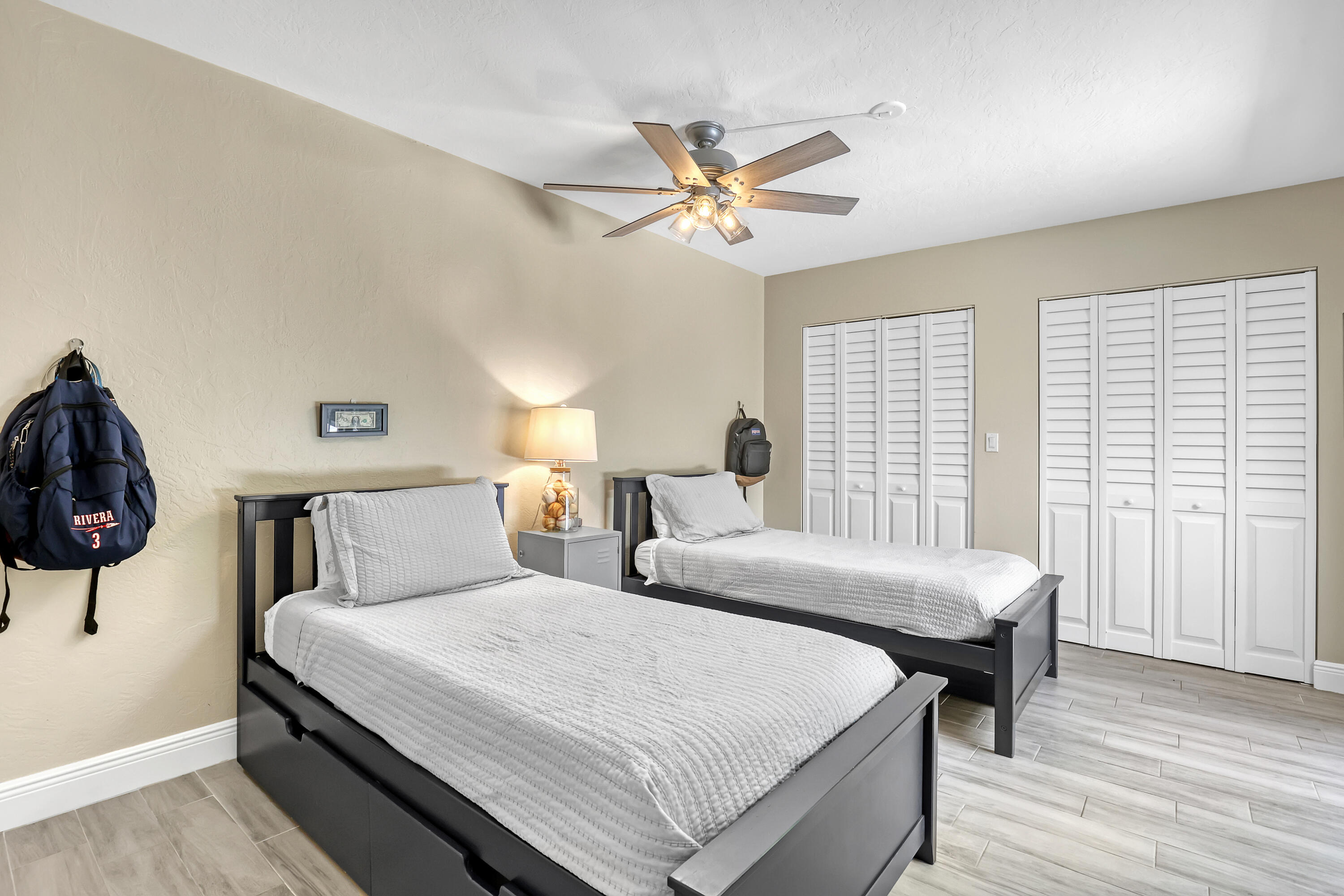 923 Springdale Circle Palm Springs, FL 33461 - Photo 24 of 26 a bedroom with a bed and a chandelier