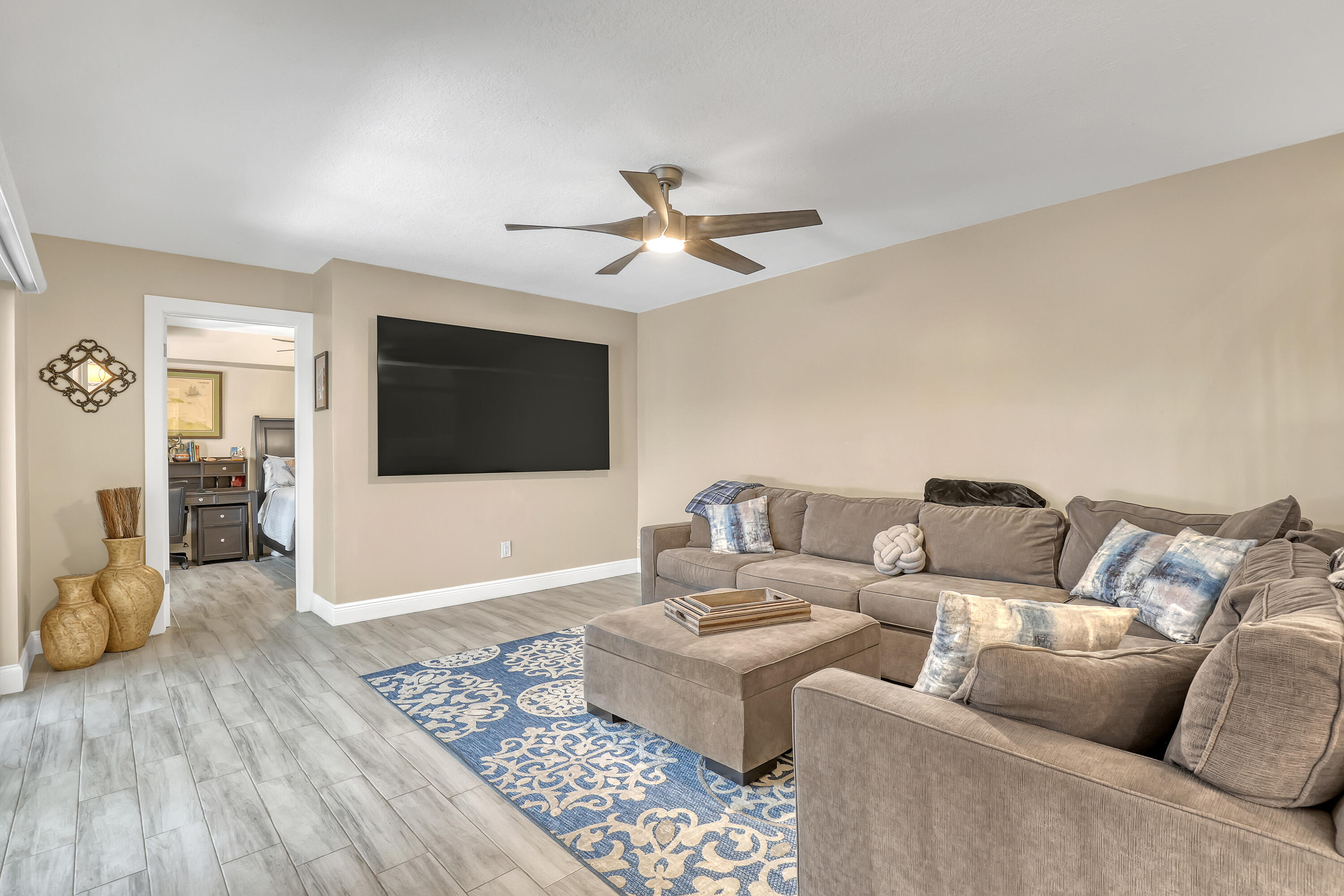 923 Springdale Circle Palm Springs, FL 33461 - Photo 9 of 26 a living room with furniture and a flat screen tv