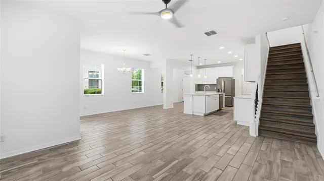 a view of a kitchen with wooden floor and a sink